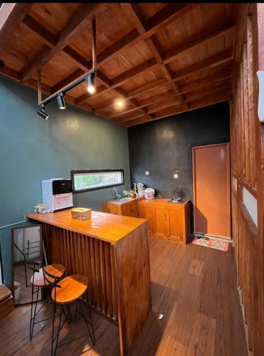 a kitchen with a counter and chairs in a room at Prisma cabin in Batur