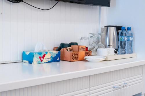 a kitchen counter with boxes and bottles of water at Meros Boutique Hotel in Samarkand