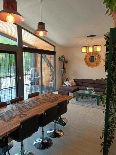a living room with a wooden table and a couch at PAMJA Guest House in Bărăşti