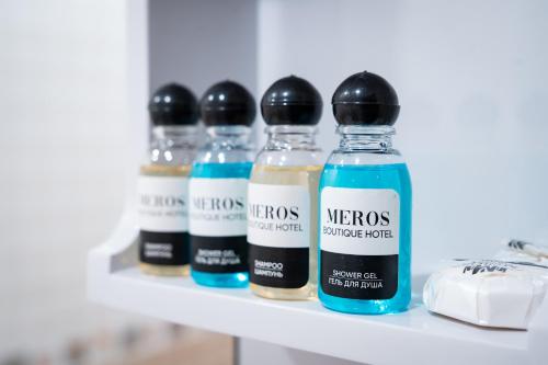 a row of bottles on a shelf at Meros Boutique Hotel in Samarkand