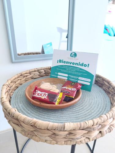 a box and a plate of food in a basket at Estudio con Increíble VISTA AL MAR de 1 a 4 huespedes in Porlamar