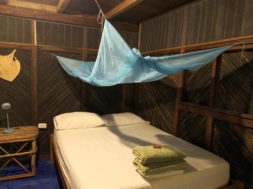a bedroom with a bed with a net on it at Chez Oliv in Palomino