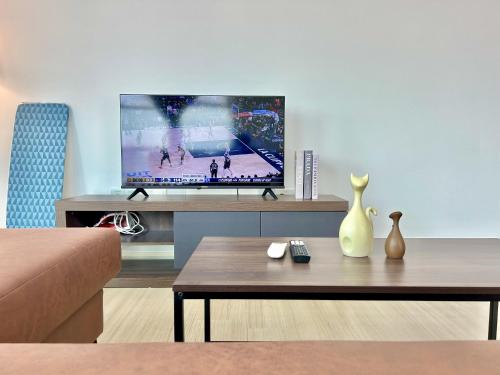 a living room with a tv and a coffee table at CozyHome 1-10pax Sunway Nexis link IOI mall & MRT in Petaling Jaya