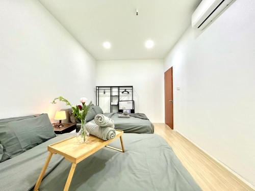 a living room with a bed and a table at CozyHome 1-10pax Sunway Nexis link IOI mall & MRT in Petaling Jaya