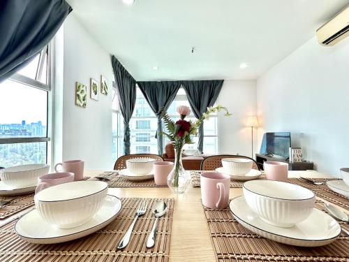 a dining room with a table with plates and utensils at CozyHome 1-10pax Sunway Nexis link IOI mall & MRT in Petaling Jaya