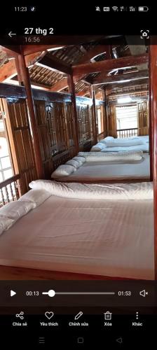 two bunk beds in a bus with a tv screen at Homestay Sung Linh in Bắc Hà