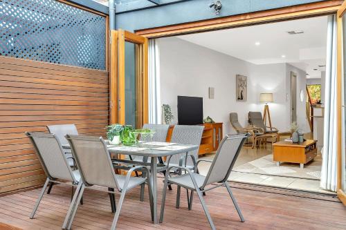 a dining room with a table and chairs at Urban Junction - Walk to Mawson Lakes Dining & Shops in Mawson Lakes