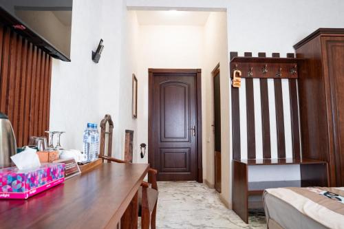 a room with a wooden desk and a door at Meros Boutique Hotel in Samarkand