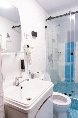 a bathroom with a sink and a toilet and a shower at Meros Boutique Hotel in Samarkand