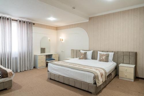 a hotel room with a bed and a desk at Meros Boutique Hotel in Samarkand