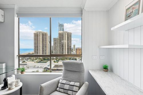 a living room with a chair and a large window at Beach Studio Ocean Views Level 17 Pool Gym Sauna in Gold Coast