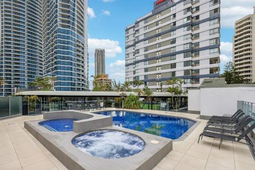 a swimming pool on the roof of a building at Beach Studio Ocean Views Level 17 Pool Gym Sauna in Gold Coast