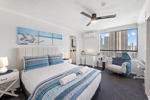 a bedroom with a bed and a chair and a window at Beach Studio Ocean Views Level 17 Pool Gym Sauna in Gold Coast