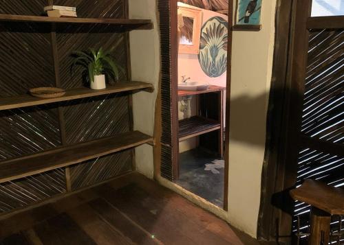 a room with wooden shelves and a mirror at Chez Oliv in Palomino