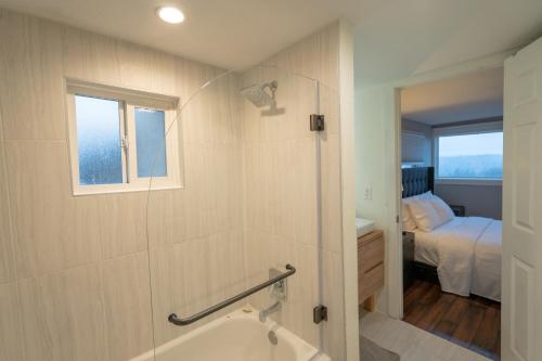 a bathroom with a bath tub and a bedroom at Craftsman with view of Seattle in Seattle