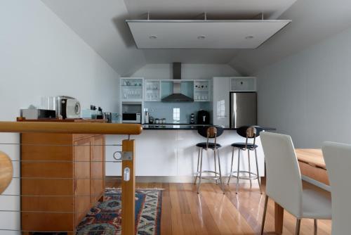 a kitchen with a counter and some stools at Cameron Mews: In The Heart Of The City in Launceston