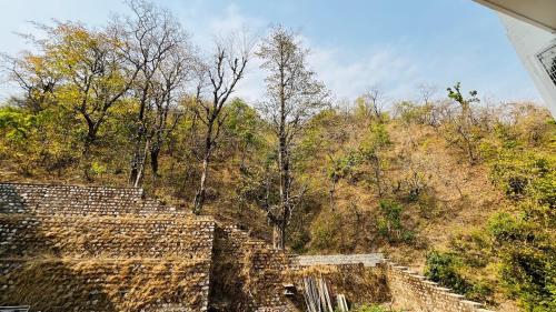 an image of an old stone building on a hill at Satvic Sthal Apartment in Rishīkesh
