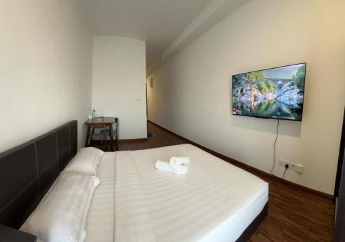 a bedroom with a large bed with a white bedspread at K Venue by IGVC in Donggongon