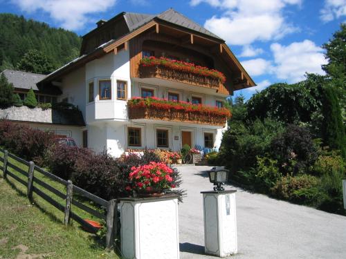 a house with flowers on the side of it at Gruber Alexandra, Appartement mit Lungaucard in Sankt Michael im Lungau