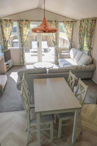 a living room with a couch and a table at Hof Nieuwerkerk Chalet 1 in Arnemuiden