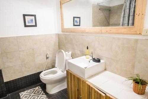 a bathroom with a toilet and a sink at Rainforest Nest - KAHILOM, SAYA, JIVA Nest with Self-Service Breakfast, Outdoor Dining, Bats! in Subic Bay Intl