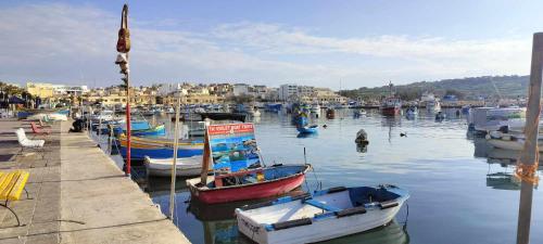 a group of boats are docked in a harbor at Trident Cove Holiday Home in Marsaxlokk