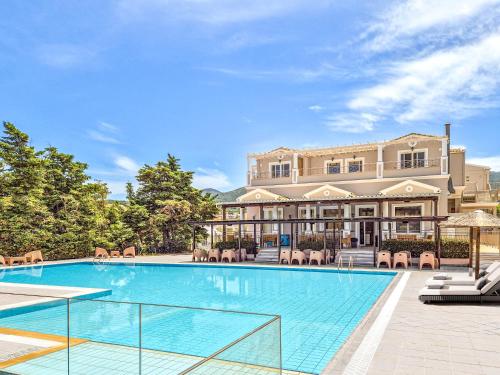 an exterior view of a mansion with a swimming pool at Thinalos Hotel in Saoúli