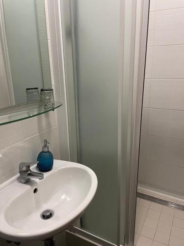 a white sink in a bathroom with a shower at Julija Palace in Split