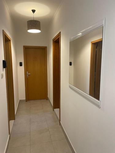 a hallway with two doors and a mirror on the wall at Julija Palace in Split