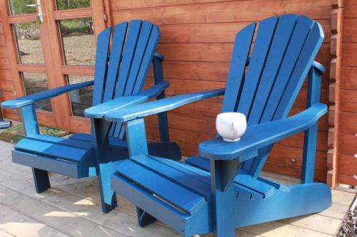 two blue chairs sitting next to each other at The Dogwood Cabin - Cowichan Valley Bunkie Glamping in Duncan