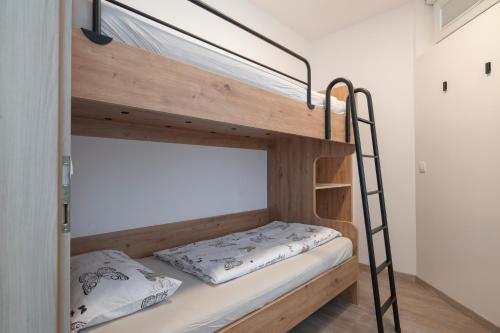 a bunk bed in a small room with a bunk bed frame at Nika & Erik in Kranjska Gora