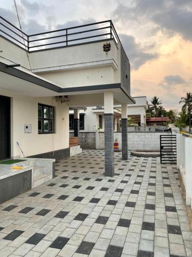 a houserendering of a patio with a house at Iraj Arunetra in Udupi