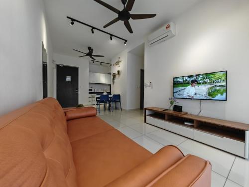 a living room with a couch and a flat screen tv at Traders Garden in Cheras