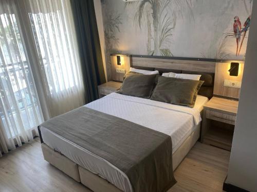 a bedroom with a large bed in a room at Akkan Beach Hotel in Bodrum City