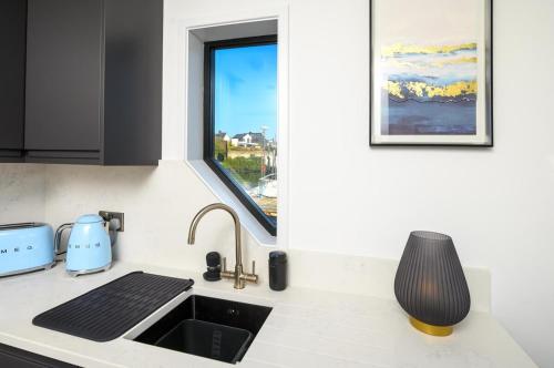 a kitchen counter with a sink and a window at Houseboat in Kinsale in Kinsale