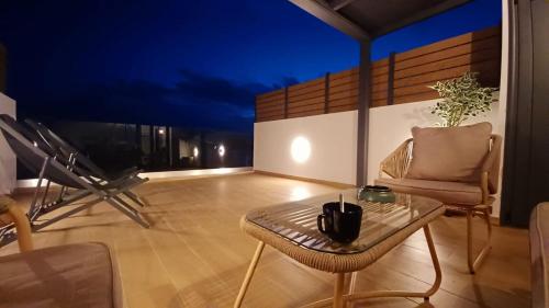 a room with a table and a chair on a balcony at attico di lusso in Komotini