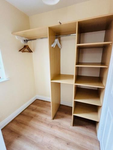 a closet with wooden shelves in a room at HarbourView House Killaloes Newest Holiday Home in Killaloe