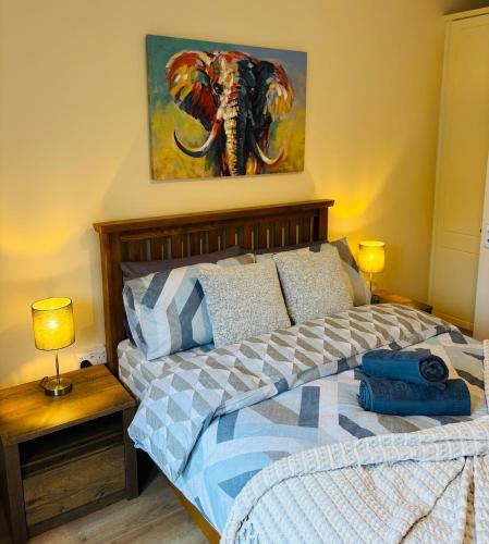 a bedroom with a bed and a painting of an elephant at HarbourView House Killaloes Newest Holiday Home in Killaloe