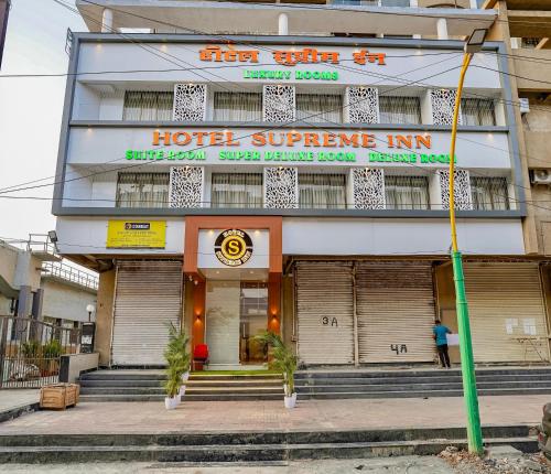 a hotel supreme inn with a man standing in front of it at Hotel Supreme Inn in Thane