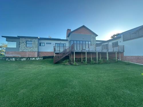 a house with a large yard with green grass at House with a View in Groot Brak Rivier