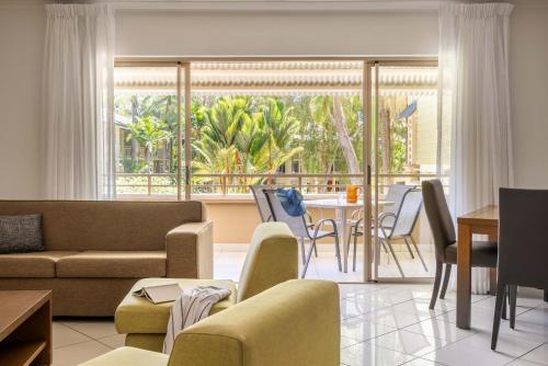 a living room with a couch and a table at Mantra Amphora in Palm Cove