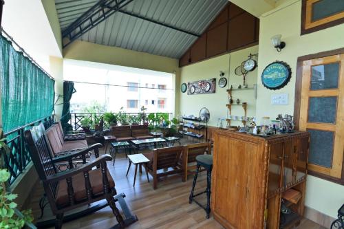 a room with a table and chairs and a dining room at Joyable Homestay Near Sankardev Netralay in Guwahati