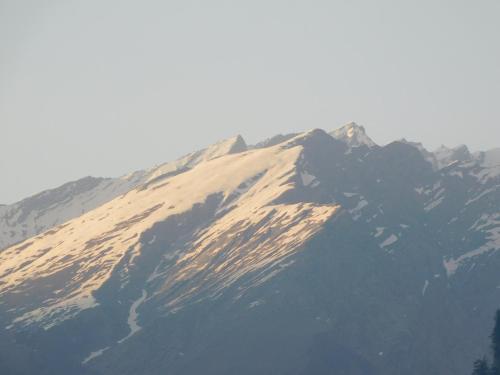 a mountain covered in snow on top of it at The Sigiriya Old manali in Manāli