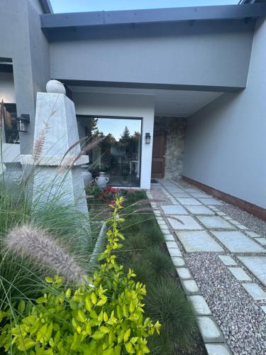 a house with a patio and a yard with plants at House with a View in Groot Brak Rivier