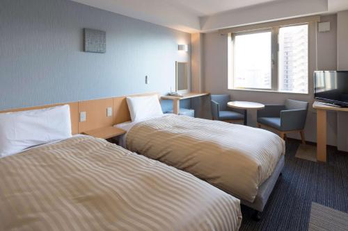 Postel nebo postele na pokoji v ubytování Comfort Inn Omihachiman