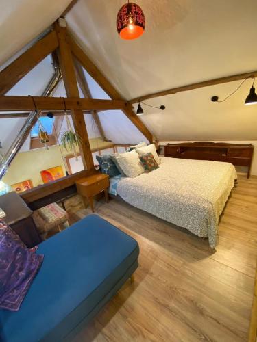 - une chambre avec un lit et un banc dans l'établissement 3 Apts Moulin SAGE, à Treignac