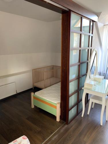 a small bedroom with a bed and a table at Nordes in Ragaciems