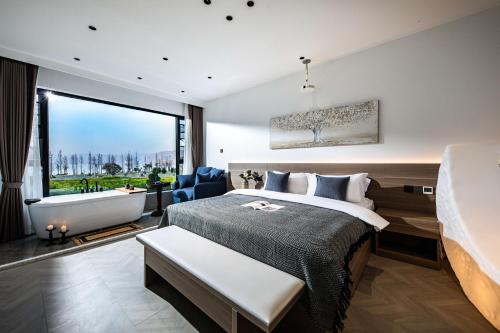 a bedroom with a large bed and a large window at Dali Water Cloud Pavilion Ocean View Guesthouse in Dali