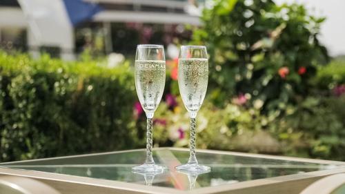 two champagne glasses sitting on top of a table at Delamar Greenwich Harbor in Greenwich