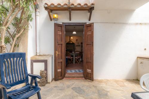 a door to a room with a chair and a table at Casa Vacanze - Domus De Mar in Stintino